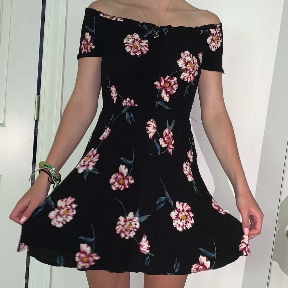 Black off the shoulder dress.